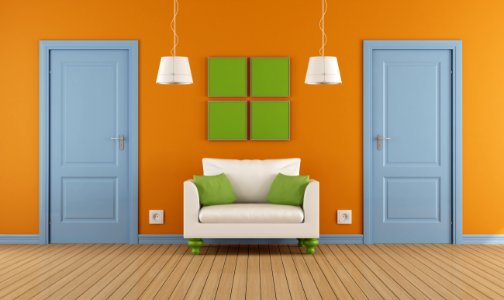 colorful interior with two blue doors and armchair