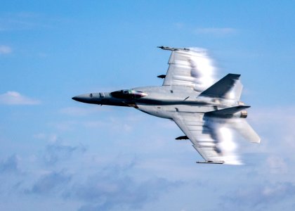 190823-N-UB406-0104 ATLANTIC OCEAN (Aug. 23, 2019) Lt. Cmdr. Benjamin Orloff, assigned to the "Blue Blasters" of Strike Fighter Squadron 34, conducts a supersonic pass in a   F/A-18E Super Hornet next to the guided-missile destroyer USS Gridley (DDG 101)