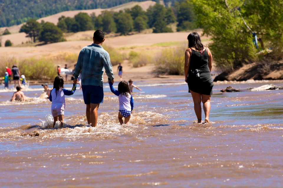 Family Walking in Medano Creek