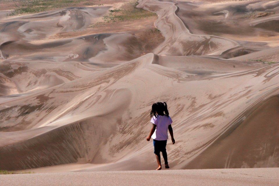 Girl Walking Barefoot on Dunes in the Early Morning