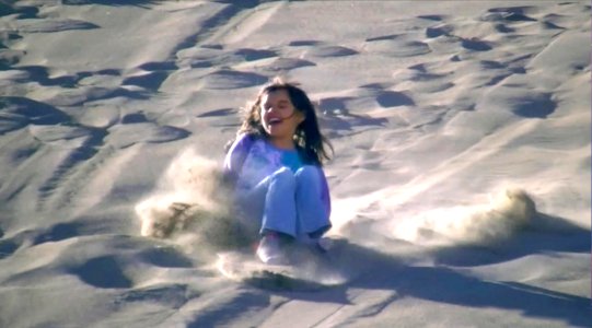 Girl Sand Sledding