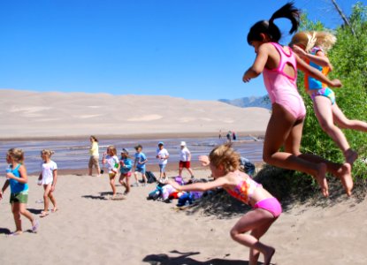 Girls Jumping Near Medano Creek