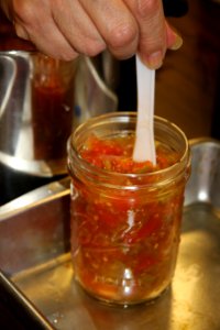 Removing air bubbles from salsa jar photo