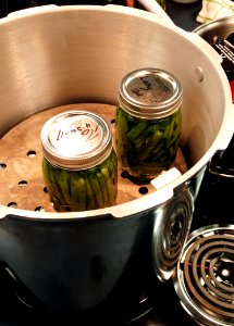 Jars being loaded into pressure canner photo