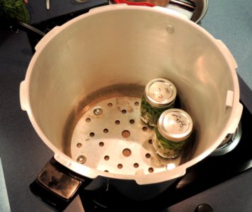 Adding jars of green beans to canner