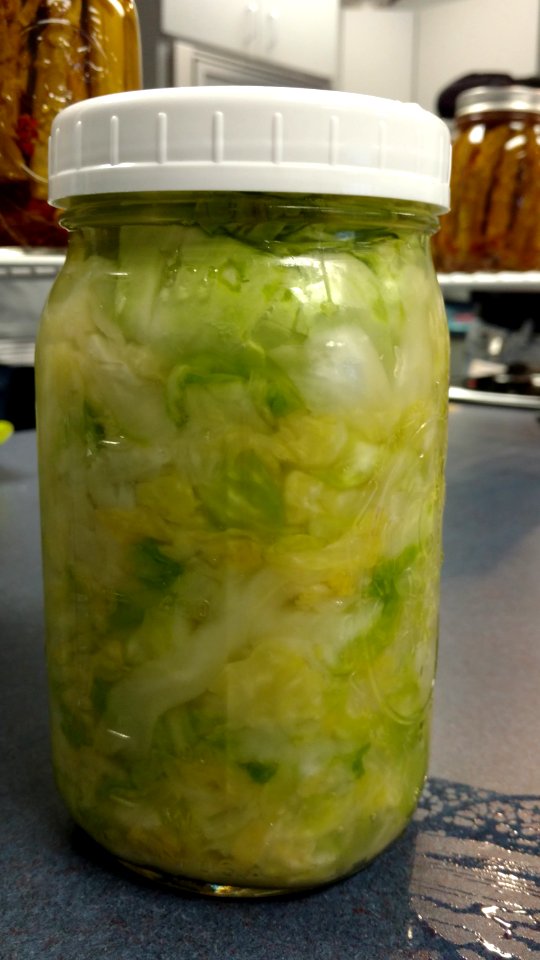 Mason jar filled with sauerkraut photo