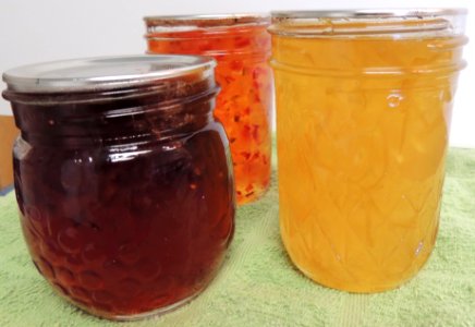 Jam and jelly jars on towel photo