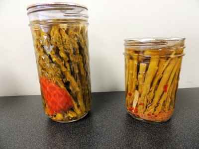 Two pickled asparagus products photo