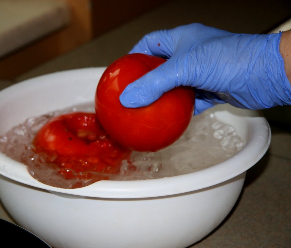 Dipping tomatoes into ice bath after boiling water for easier peeling