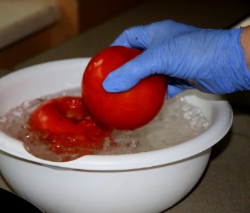 Dipping tomatoes into ice bath after boiling water for easier peeling