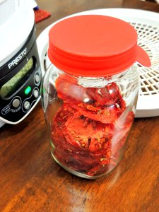 Mason jar being used for conditioning tomatoes photo