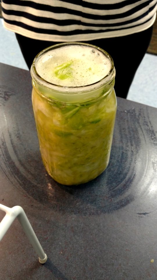 Sauerkraut in mason jar with foam on top