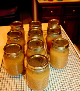 Cooling jars of applesauce on rack