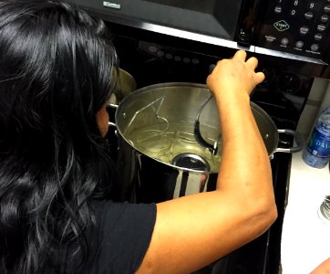 Removing hot jars from canner prior to filling photo