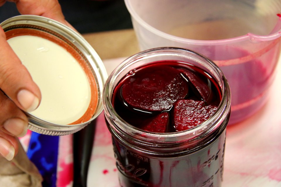2-piece lid being added to pickled beet jar