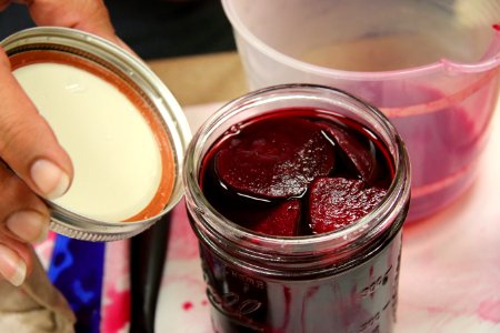 2-piece lid being added to pickled beet jar photo