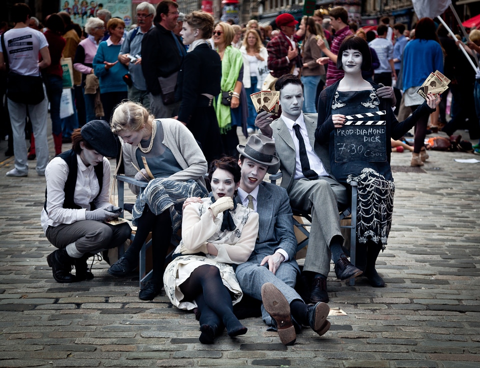 Performers make up costumes