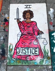 Portrait of Justice - a Black Woman Holding a Sword and Scales photo