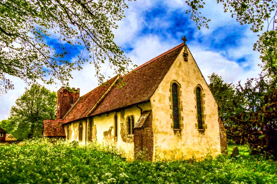 Redundant parish church. C12, C13 chancel, west tower rebuilt 1807, WilliamMoss, restored 1881-1884, south porch 1889. Rendered flint and rubble withsome re-used Roman brick, red brick tower and plain tiled roof. Chancel,nave, south-west tower and south p