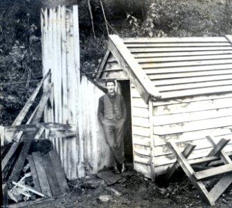Mr Maxwell outside workers house, Waipori