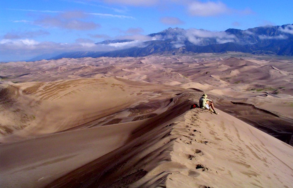Hiker on Top of High Dune, Panoramic View