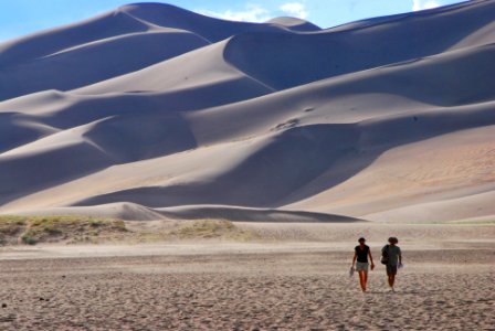 Couple Walking at Base of Dunes photo