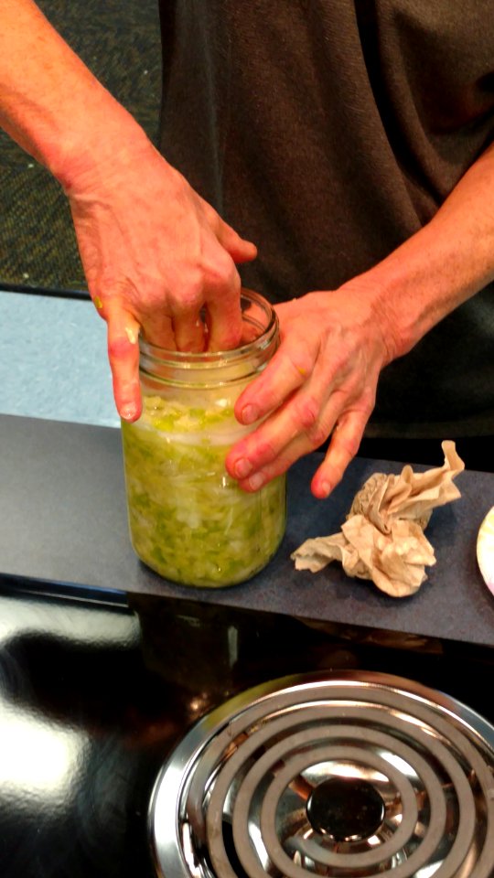 Compacting cabbage down into mason jar