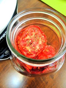 Dried tomatoes in mason jar photo