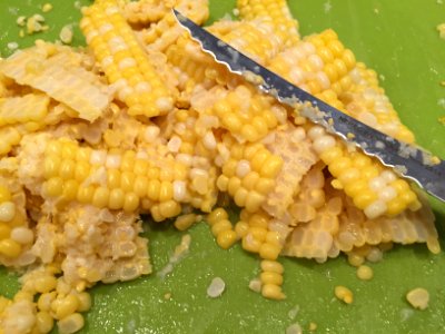 Corn removed from cob on cutting board