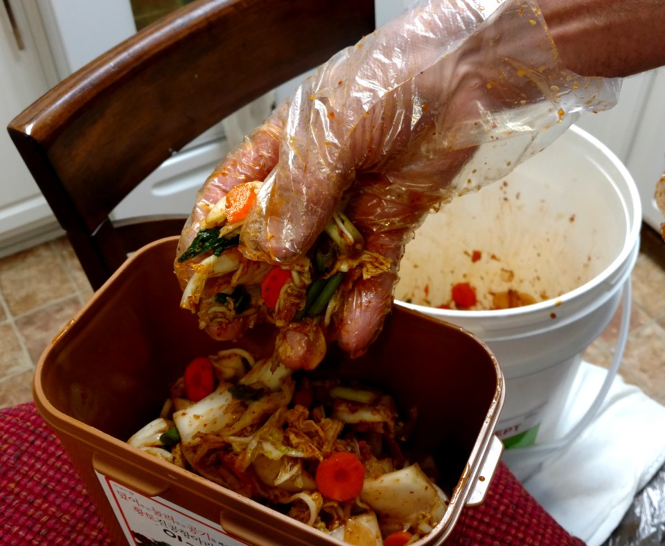 Adding kimchi to the fermentation container