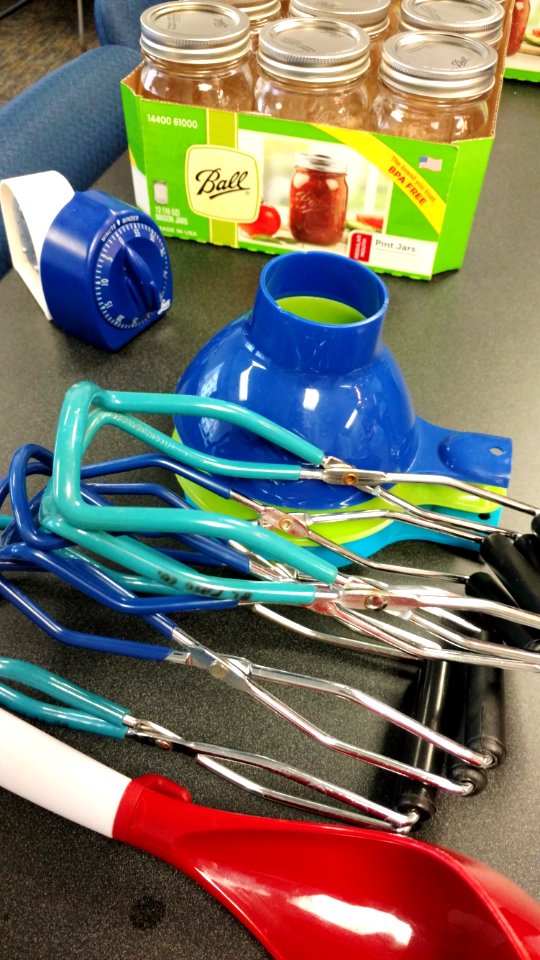 Canning supplies-jars, jar lifters, funnels, ladle, and timers
