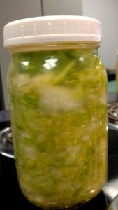 Mason jar filled with fermenting cabbage photo