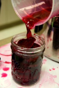 Adding vinegar solution to pickled beets jar photo