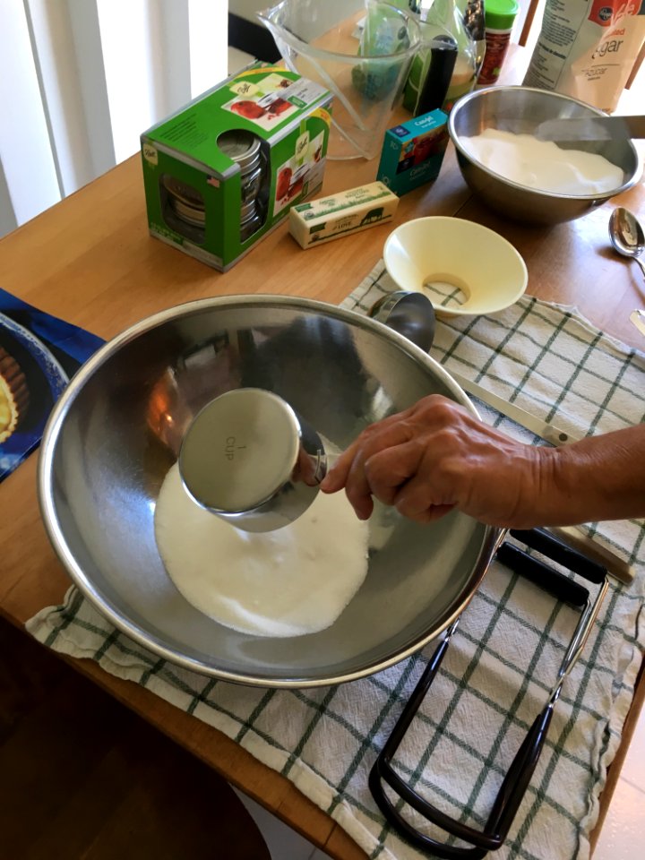 Measuring out sugar for peach jam