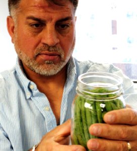 Man holding canned green beans
