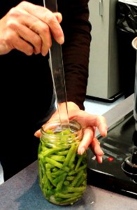 Removing bubbles in jar for canning green beans photo