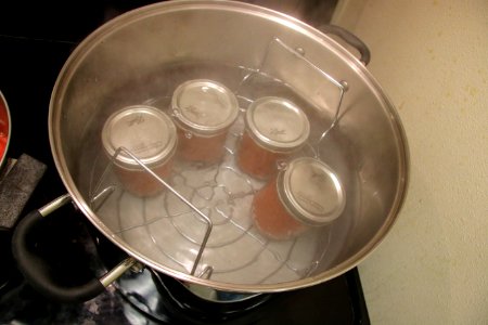 Canned tomatoes in boiling water canner