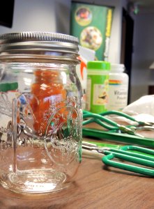 Mason jar with home canning supplies