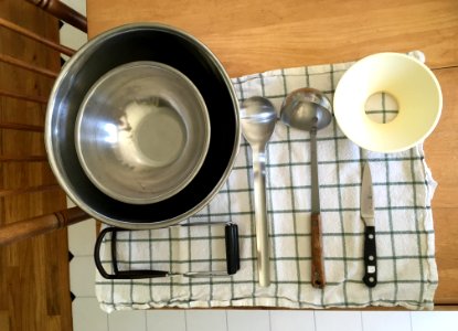 Cleaned jam making supplies: bowls, spoon, funnel, knife, ladle, jar lifter photo