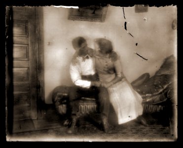 Couple on loveseat, c1913 photo