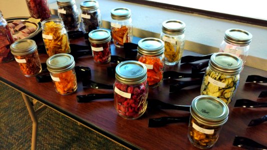 Jars of dried foods and tongs for sampling