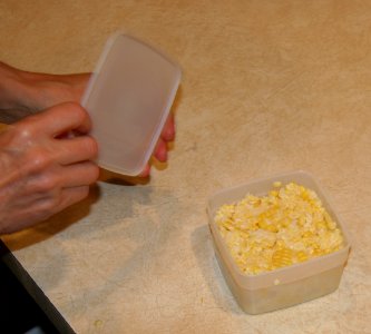 Placing lid on freezer container