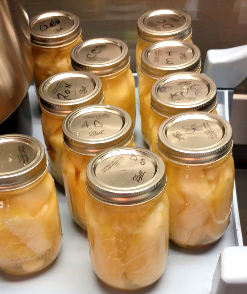 Canned pears in mason jars on counter