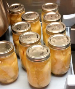 Canned pears in mason jars on counter photo