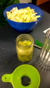 Shredded cabbage, mason jar, and funnel