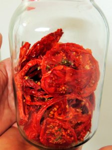Dried tomatoes in conditioning jar photo