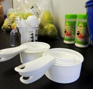 Measuring cups and spoons with pears and Fruit-Fresh photo