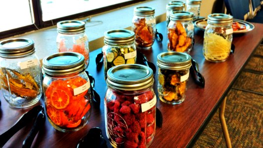 Dehydrated fruits and vegetables in labeled mason jars photo
