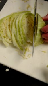 Shredding cabbage for sauerkraut photo