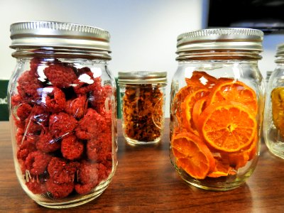 Mason jars with dehydrated raspberries and oranges